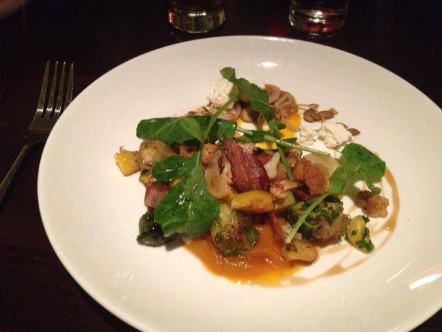 A composed restaurant plate dressed with fresh greens from Vertical Paradise Farms